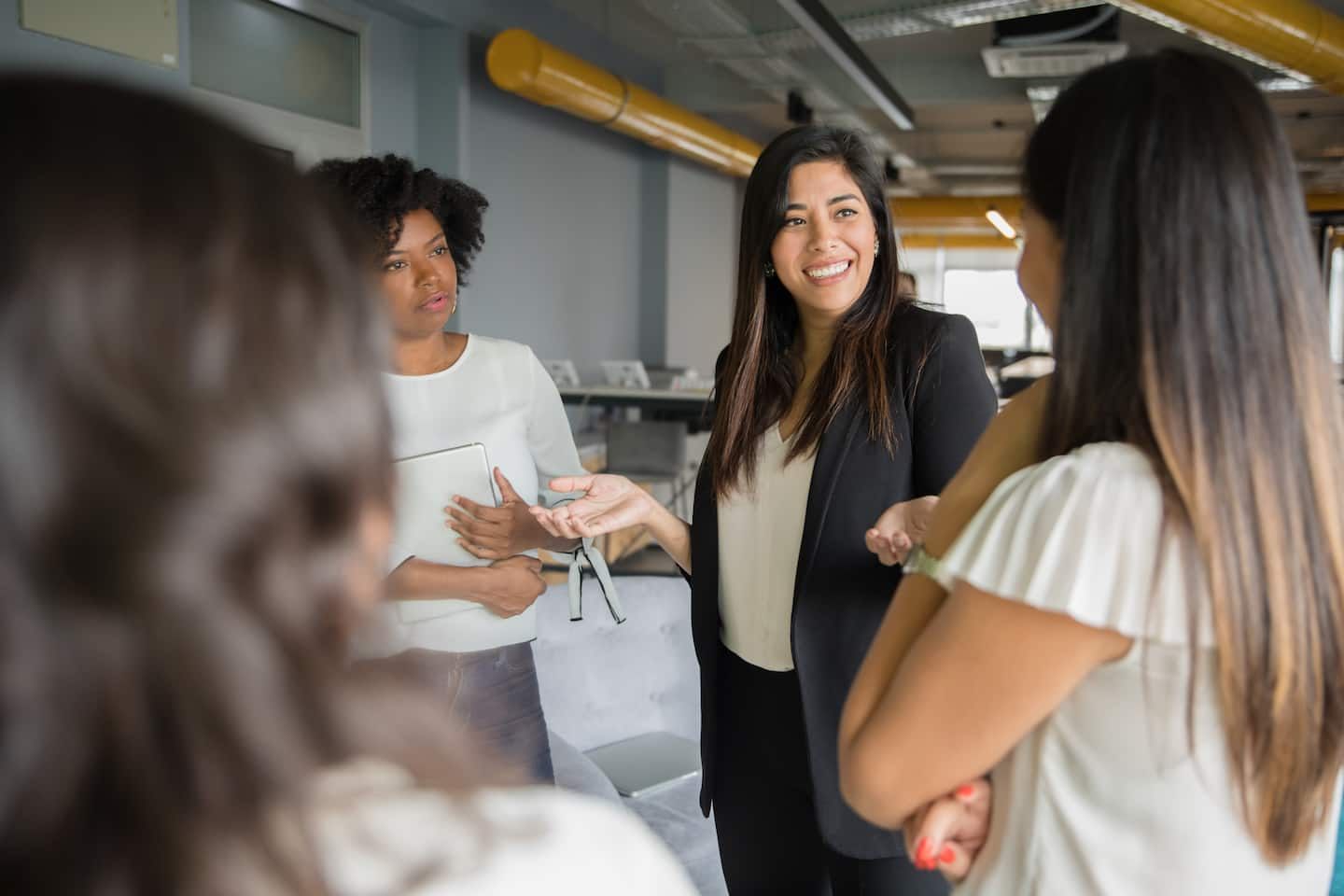 Women in tech talking during a meeting