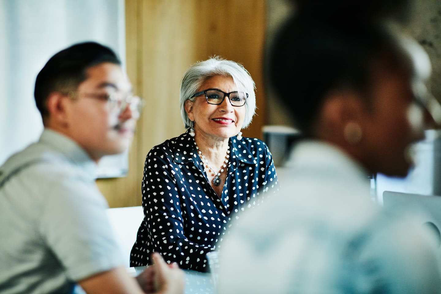 Smiling businesswoman listening during presentation 