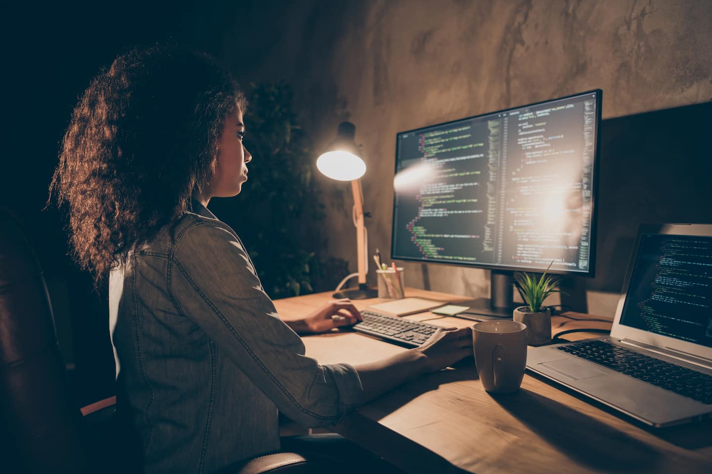 Profile side photo of focused company administrator sitting at a desk .