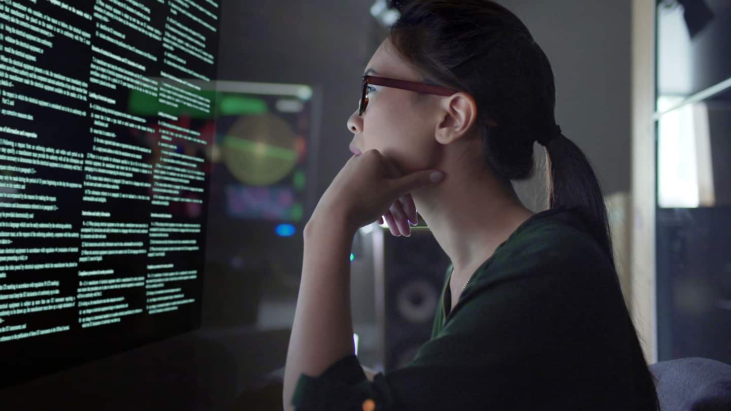 A young woman looking at a computer screen