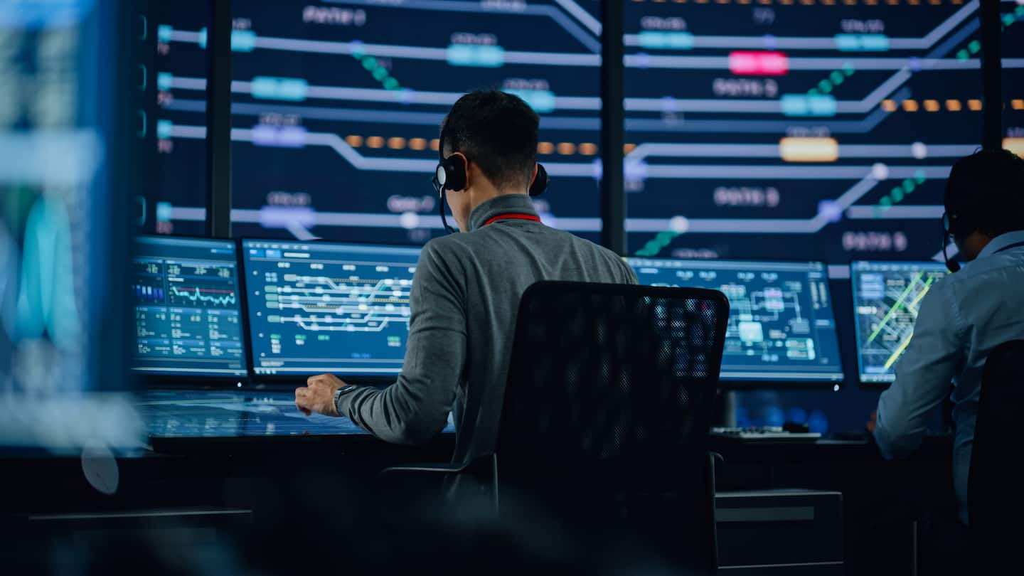 Professional IT Technical Support Specialists and Software Programmer Working on Computers in Monitoring Control Room with Digital Screens with Server Data, Blockchain Network and Surveillance Maps. 