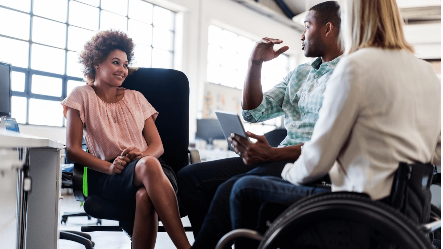 Three individuals sit near each other having a discussion